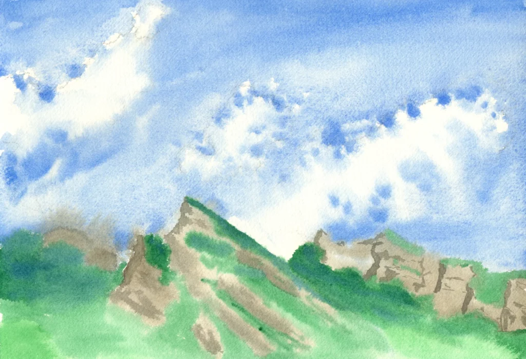 A bright watercolor painting of jagged, green-covered mountain peaks reaching up into a vivid blue sky filled with large, fluffy white clouds.